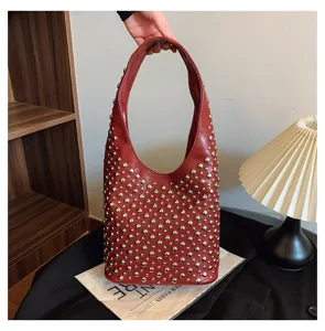 Red punk style hobo bag with silver round rivet studs and smooth leather finish.