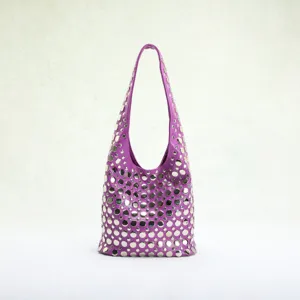 Close-up of a purple punk-style hobo bag with silver stud embellishments.