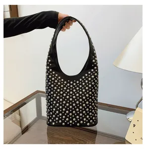 Fashionable black punk style women's bucket bag featuring silver rivet embellishments
