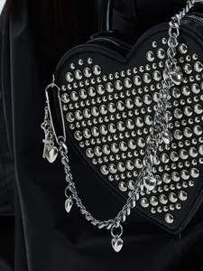 Black heart-shaped studded handbag with chain strap, goth punk style crossbody bag for women.