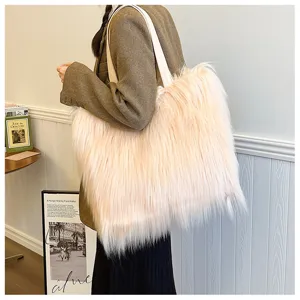 Detail view of peach pink faux fur tote bag with long plush texture and white straps