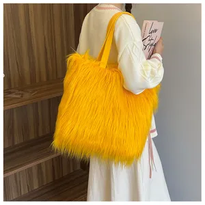 Detailed side view of a large fluffy yellow faux fur tote bag held by a fashion model