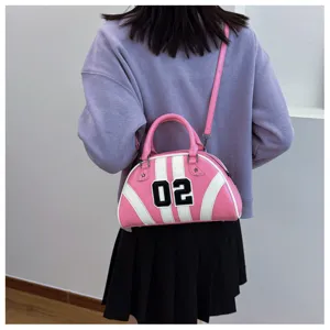 Stylish pink and white bowling bag with '02' patch worn by a model in casual attire