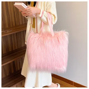 Stylish pink long hair faux fur tote bag held by a model in an indoor lifestyle setting