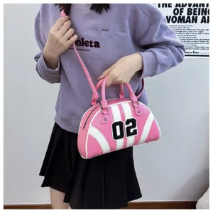 Pink bowling handbag with white stripes and number 02 patch shown in lifestyle setting