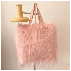 Detail of pink faux fur tote bag showing the soft long pile texture and leather handles
