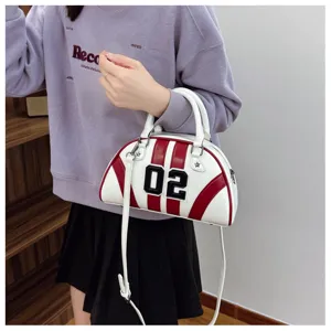 Close-up of a stylish white and red striped bowling handbag featuring a digital '02' patch