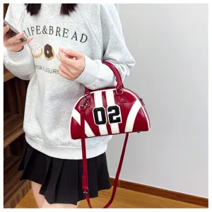 Detail of a red and white bowling bag with 02 numeric decoration for women.