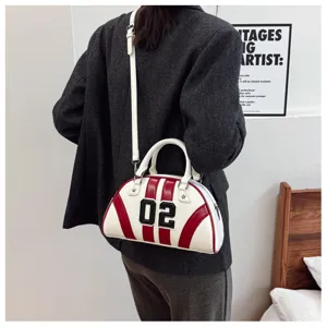 Model carrying a vintage-style color-block bowling handbag with 02 patch decoration.