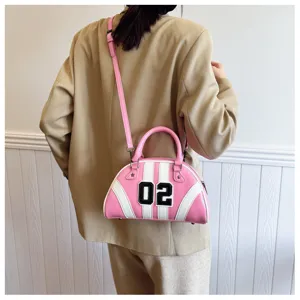 Detailed view of a pink and white patchwork bowling bag with 02 number patch on a model