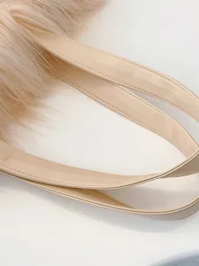 Close-up of creamy beige faux fur tote bag with durable PU leather shoulder straps.