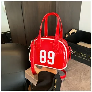 Close-up of stylish red bowling handbag with number 89 print and shiny leather texture