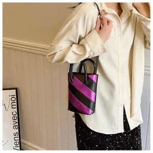 Detailed shot of a stylish mini PU bucket bag with purple and black diagonal stripes