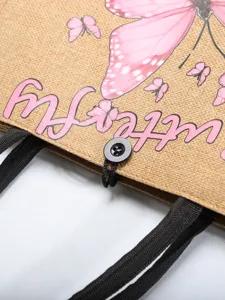 Close-up detail of eco-friendly jute tote bag with pink butterfly print and button closure