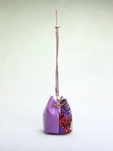 Side view of purple bucket bag with vibrant floral embroidery and red sequins
