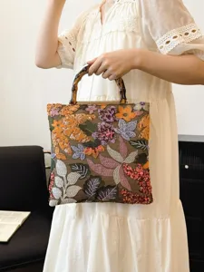 Linen handbag with bamboo handles, vibrant floral embroidery, and sparkling sequins detail