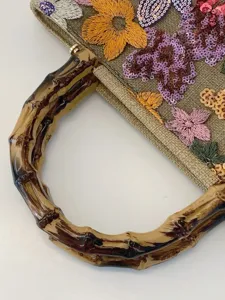 Linen handbag with bamboo handle featuring intricate floral embroidery and sequins