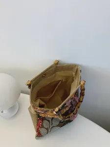 Elegant linen handbag featuring bamboo handles and detailed floral sequin embroidery