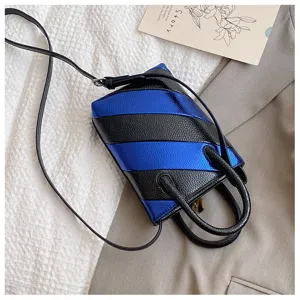 Close-up detail of metallic blue and black striped bucket bag in premium PU leather material