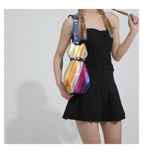 Model wearing a cat-shaped crossbody bag with vibrant rainbow metallic stripes
