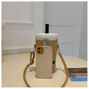 Detail view of a boba tea shaped crossbody bag with a phone for size comparison