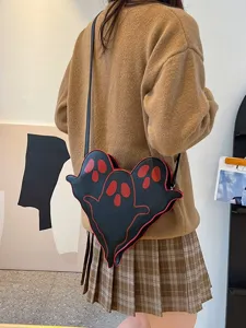 Black ghost-shaped crossbody bag with red face details for Halloween costume party