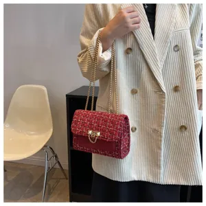 Elegant red tweed chain bag with gold hardware shown on a model wearing a corduroy blazer