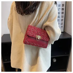 Red tweed chain crossbody bag in chic vintage style worn by a model in beige jacket