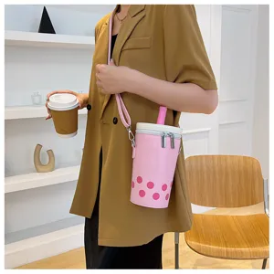 Detail of a pink bubble tea shaped crossbody bag with a decorative straw