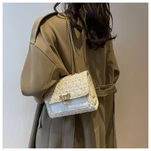 Rear view of a tweed plaid square crossbody bag with gold chain strap