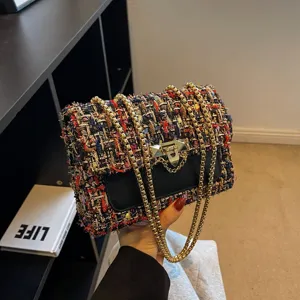 Elegant multi-color tweed chain shoulder bag featuring a metallic clasp and fringe detail.