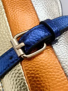 Close-up of fashion contrast color crossbody bag with textured metallic finish