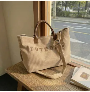 Casual corduroy tote bag with top handle and shoulder strap for daily commuting use.