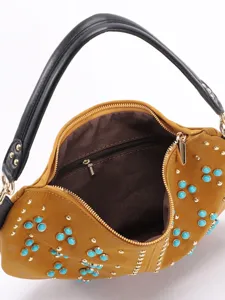 Vintage yellow crescent bag with turquoise studs and black handle for retro chic style.