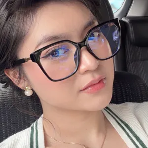 Close-up of stylish woman wearing vintage square cat-eye glasses in black frame accessory