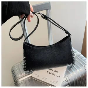 Detailed view of the trendy black punk style shoulder bag with metal chain ring accents.