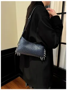 Detailed view of a black textured shoulder bag featuring unique metal ring charms.