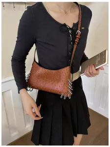 Punk style brown ostrich texture shoulder bag with metal rings for women daily wear.