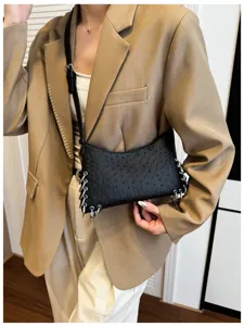 Black textured leather shoulder bag with punk metal rings and chain details for women.