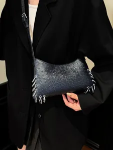 Punk style black shoulder bag with metal rings, trendy niche design for women's fashion.