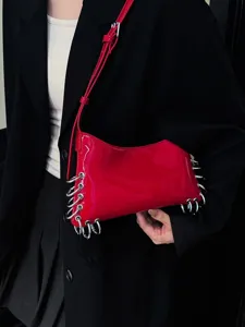 Red patent leather shoulder bag with metal ring punk design, stylish underarm handbag.