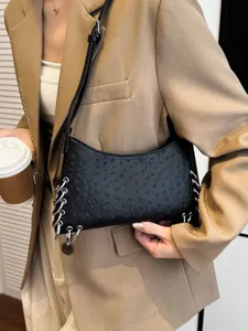 Black punk style underarm shoulder bag for women with chic metal rings and unique textured design.
