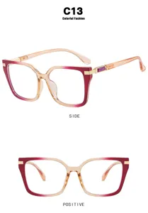 Detail view of oversized square sunglasses with red gradient frames and gold accents.
