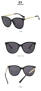 Lunettes de soleil cat-eye classiques pour femme avec branches chaînées dorées et monture noire.
