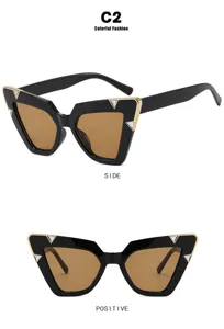 Detail view of cat-eye sunglasses with gold V-accents and diamond-encrusted frames.