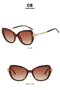 Detailed view of cat-eye tortoiseshell sunglasses with rhinestone-accented temples