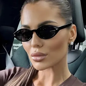 Chic retro black cat-eye sunglasses featuring star studs, showcased on a model in a car