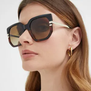 Close-up of woman wearing stylish irregular oversized sunglasses with brown gradient lenses