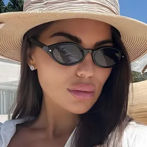 Close-up of trendy black oval retro sunglasses with star rivet details for women