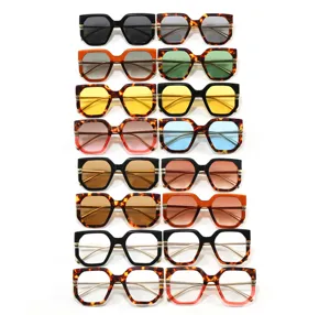 Detailed view of various colorful irregular large frame sunglasses on white background